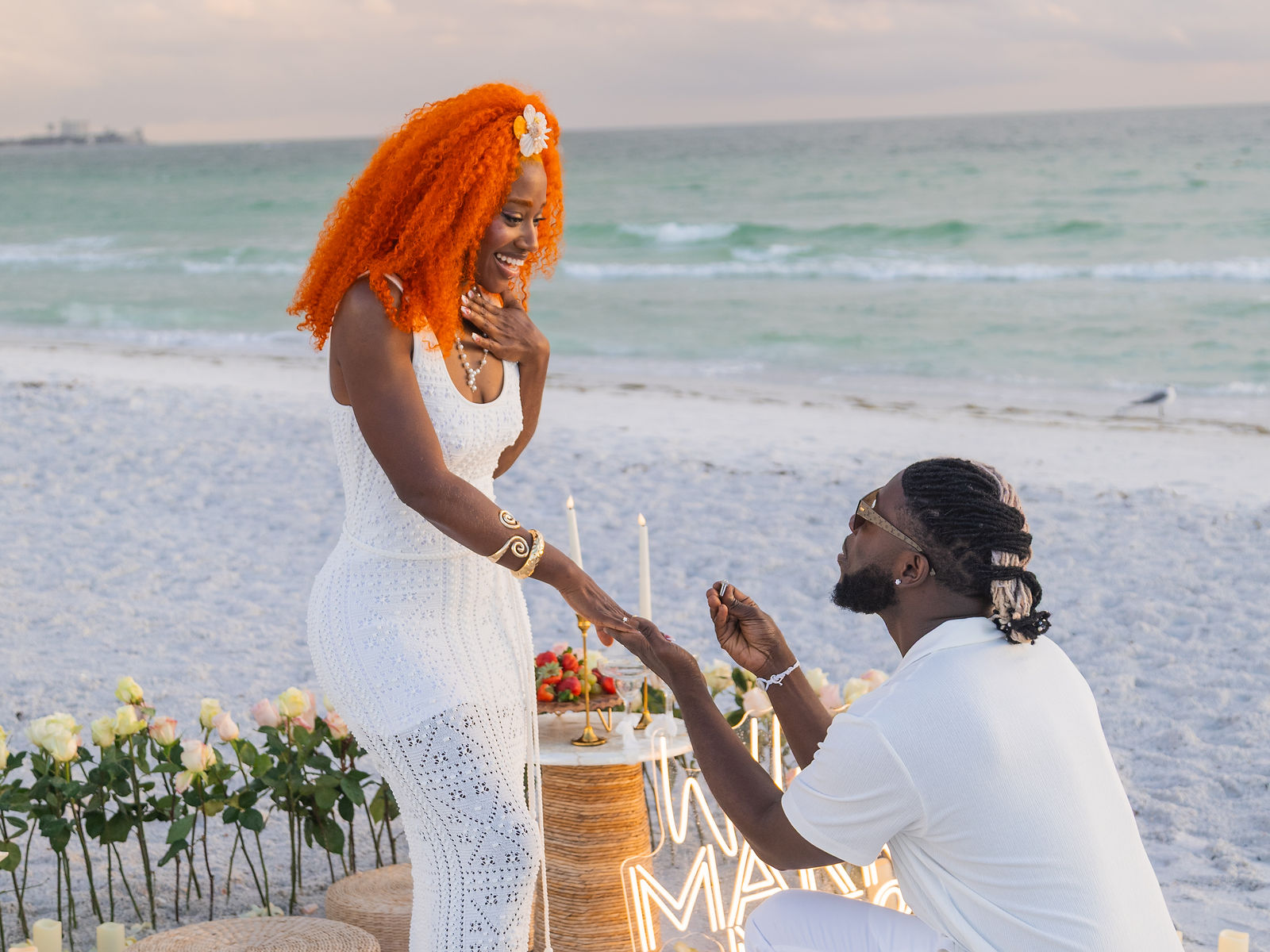 Couple at a Coastal Love beach proposal