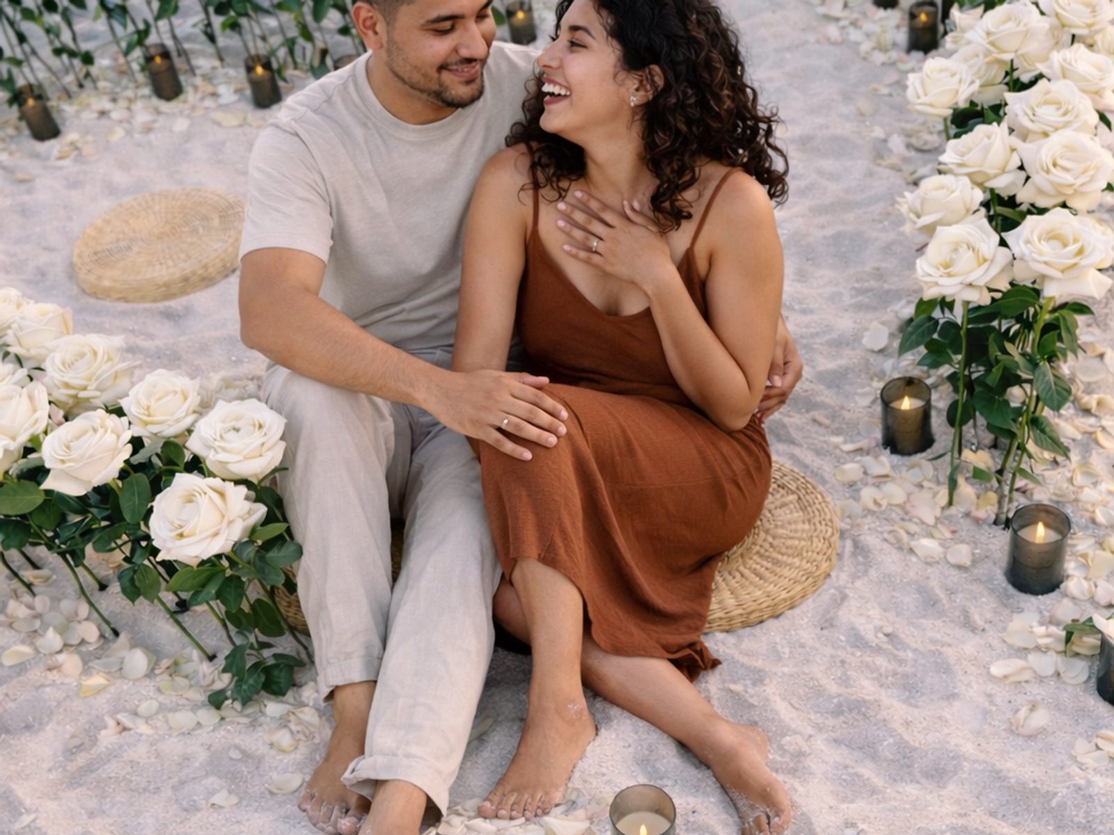Couple surrounded by white roses at a Beach Bloom proposal